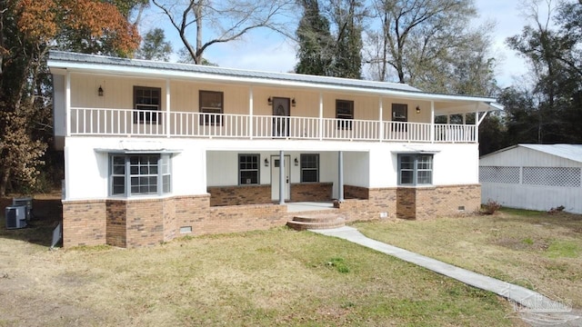 view of front facade featuring central air condition unit, a balcony, and a front lawn