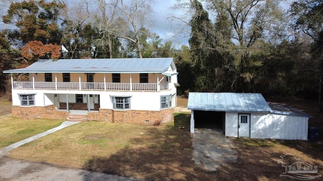 view of front of home with a front yard and an outdoor structure