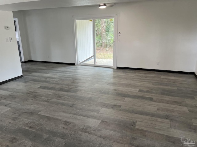 empty room with dark hardwood / wood-style flooring