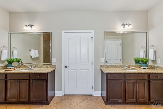 full bath with a sink, two vanities, and tile patterned flooring