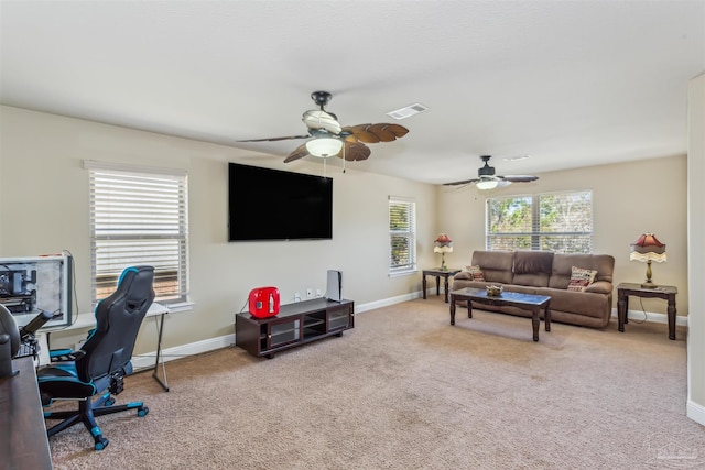 living room featuring baseboards, carpet, and a ceiling fan