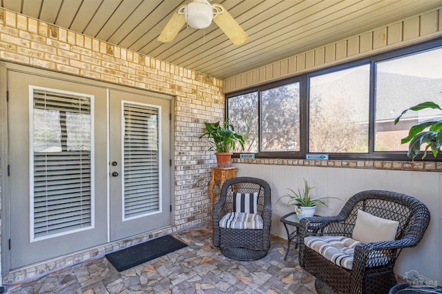 sunroom with a ceiling fan and wood ceiling