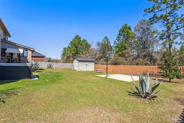 view of yard with a patio, an outbuilding, a fenced backyard, and a storage shed