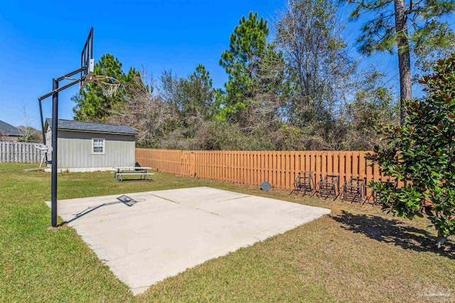 exterior space with an outdoor structure, basketball court, and a fenced backyard