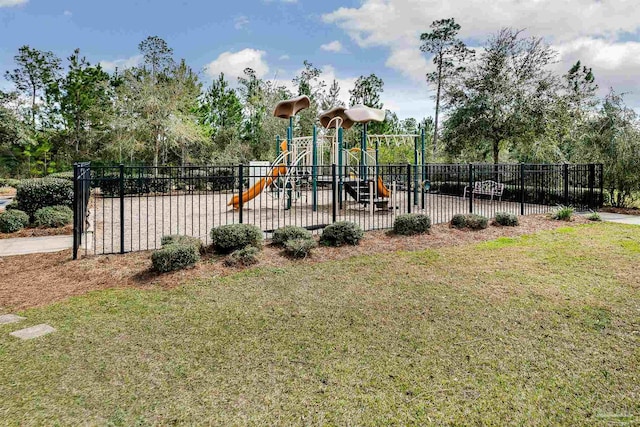 community jungle gym with fence and a lawn