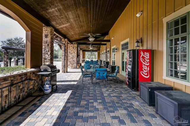 view of patio featuring outdoor dining area, a grill, and ceiling fan