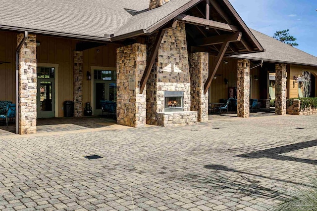 view of patio with an outdoor stone fireplace