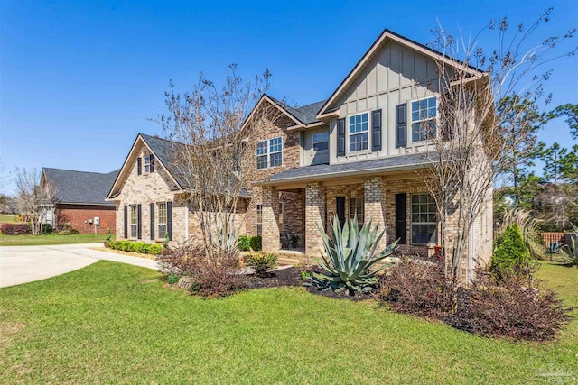 craftsman-style house featuring driveway, brick siding, board and batten siding, and a front lawn