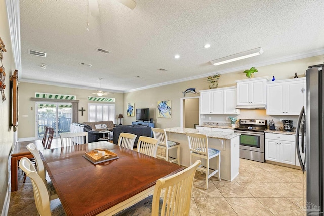 dining space featuring crown molding, visible vents, and a ceiling fan