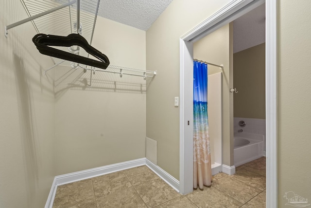 walk in closet featuring tile patterned flooring