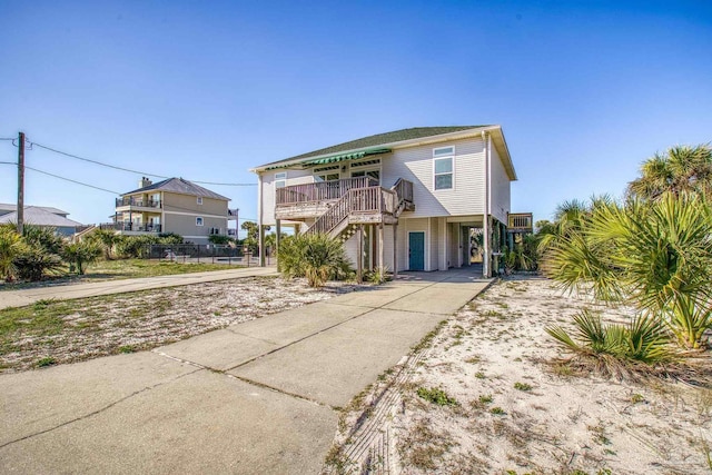 raised beach house featuring driveway