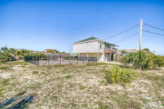 view of yard with fence and stairway