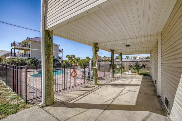 view of patio / terrace featuring visible vents, a community pool, and fence