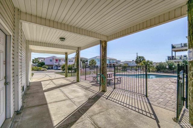 view of patio featuring fence and a community pool