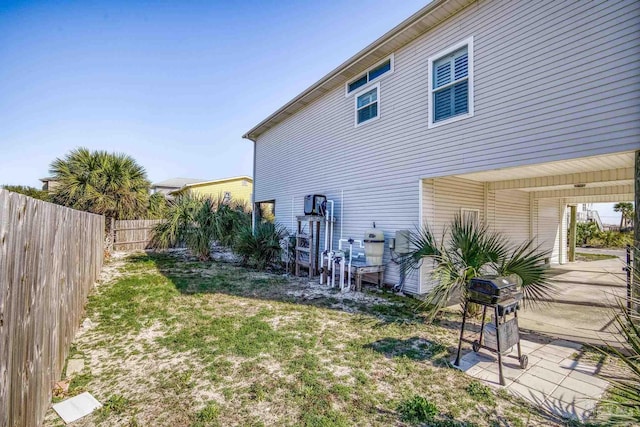 exterior space featuring a patio, a lawn, and fence