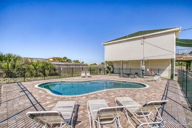 community pool featuring a patio and fence