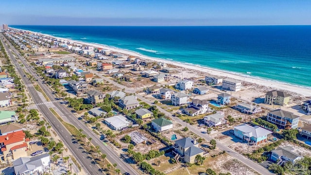 drone / aerial view with a water view and a beach view