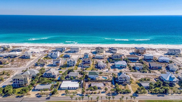 bird's eye view with a beach view, a water view, and a residential view