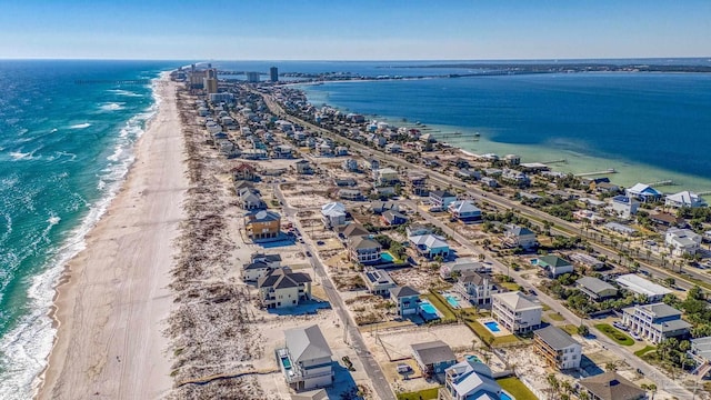 drone / aerial view with a beach view and a water view