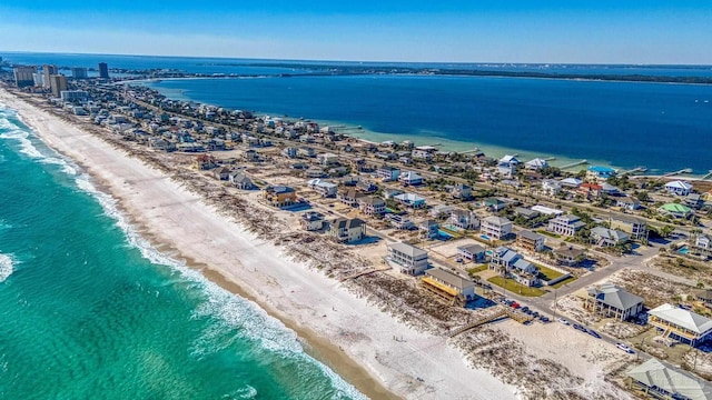 drone / aerial view with a water view and a view of the beach