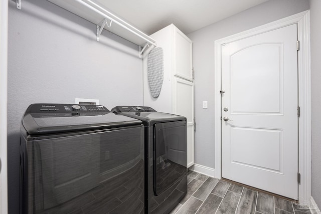9074 Byrom Campbell Rd, Pace, FL 32571 - laundry area with independent washer and dryer, cabinet space, wood tiled floors, and baseboards