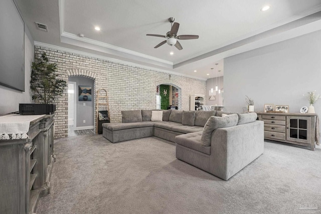 9074 Byrom Campbell Rd, Pace, FL 32571 - carpeted living area featuring a ceiling fan, a fireplace, a raised ceiling, brick wall, and recessed lighting