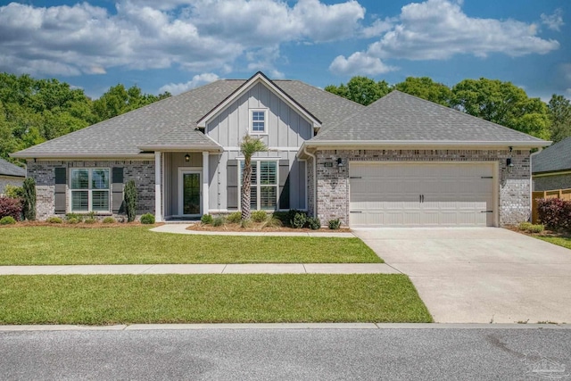 craftsman-style home featuring a front lawn, driveway, board and batten siding, an attached garage, and roof with shingles