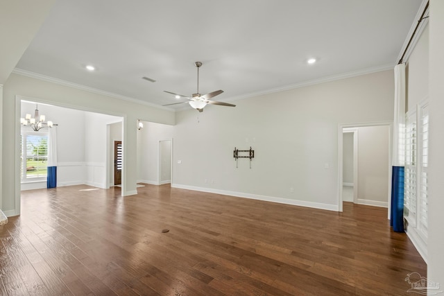 unfurnished living room with baseboards, ornamental molding, dark wood-type flooring, and ceiling fan with notable chandelier