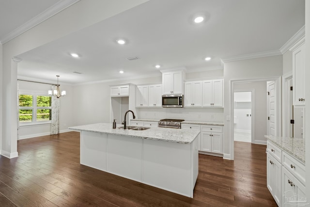kitchen with ornamental molding, appliances with stainless steel finishes, a sink, and white cabinetry