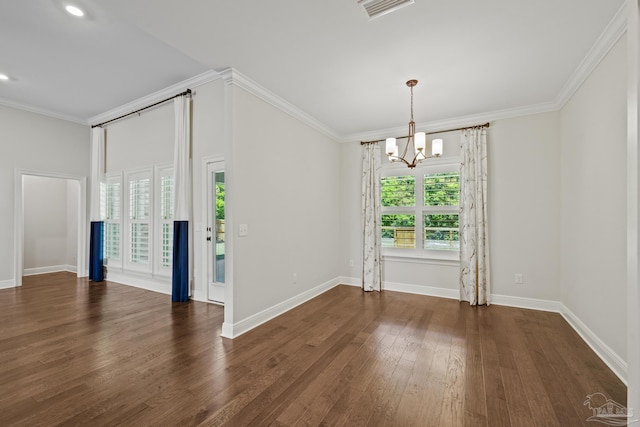 spare room with ornamental molding, baseboards, a notable chandelier, and wood finished floors