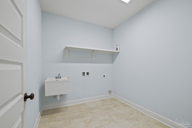 clothes washing area with a sink, baseboards, hookup for a washing machine, electric dryer hookup, and laundry area