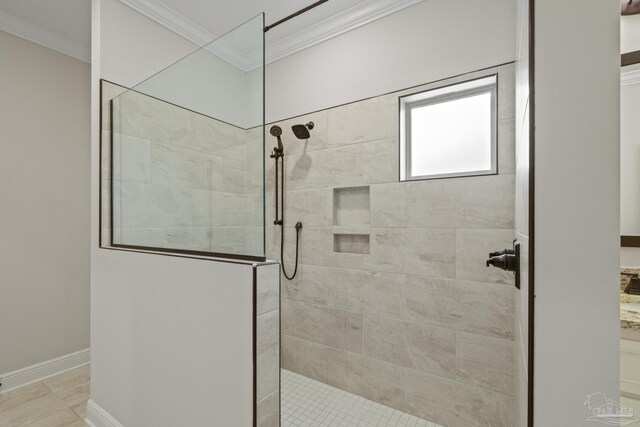 bathroom featuring ornamental molding and a walk in shower