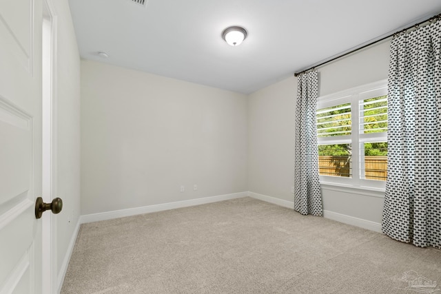empty room with baseboards and carpet flooring