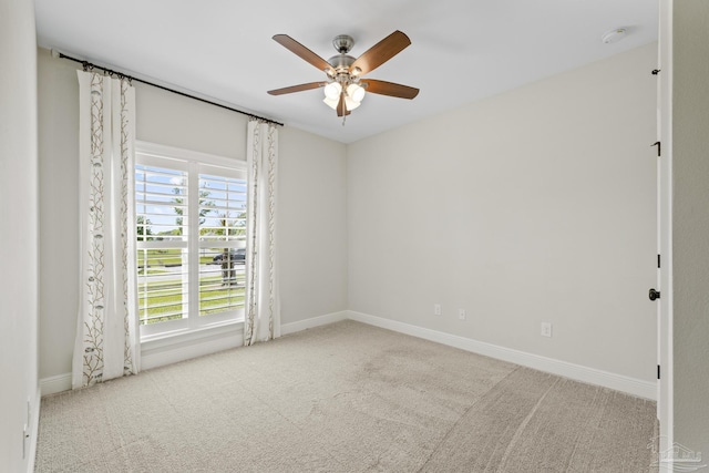 empty room featuring baseboards, a ceiling fan, and carpet flooring
