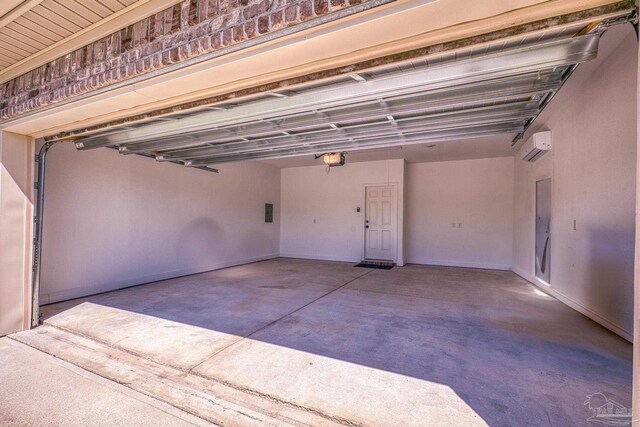 garage with an AC wall unit, a garage door opener, and baseboards