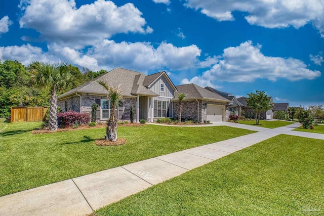 ranch-style home with a front lawn, fence, driveway, and a garage