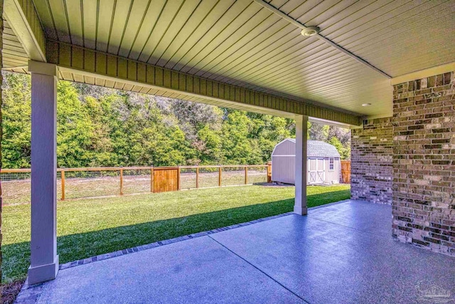 view of patio / terrace featuring a fenced backyard, an outdoor structure, and a shed