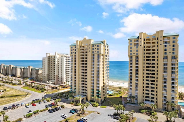 birds eye view of property with a water view and a beach view