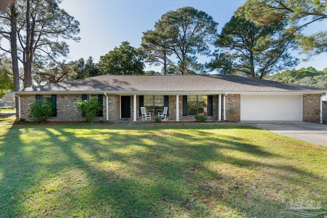 single story home featuring covered porch, a garage, and a front lawn