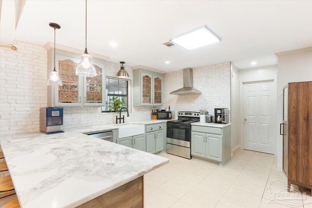 kitchen with wall chimney range hood, backsplash, crown molding, pendant lighting, and appliances with stainless steel finishes