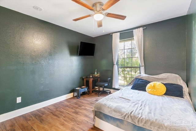 bedroom with hardwood / wood-style floors and ceiling fan