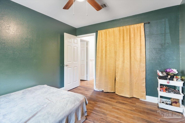 bedroom with hardwood / wood-style floors and ceiling fan