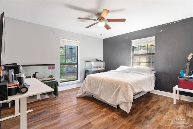 bedroom featuring ceiling fan and hardwood / wood-style flooring