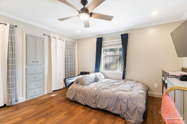 bedroom with ornamental molding, ceiling fan, and dark wood-type flooring