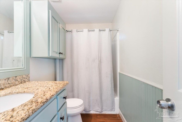 full bathroom with hardwood / wood-style flooring, vanity, toilet, and shower / bath combo