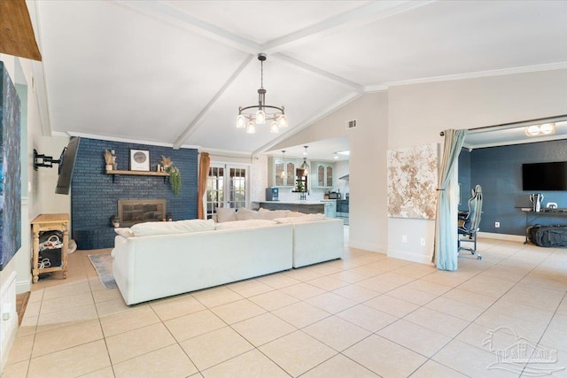 tiled living room with a brick fireplace, lofted ceiling with beams, an inviting chandelier, and ornamental molding