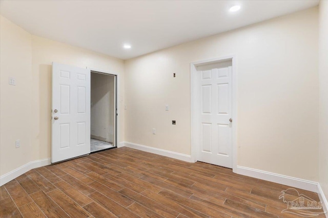 unfurnished room with dark hardwood / wood-style floors