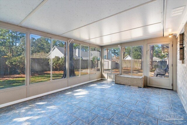 unfurnished sunroom with a wealth of natural light