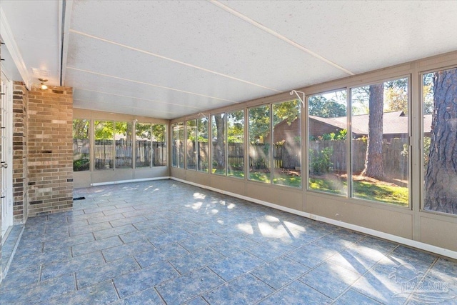 unfurnished sunroom with lofted ceiling