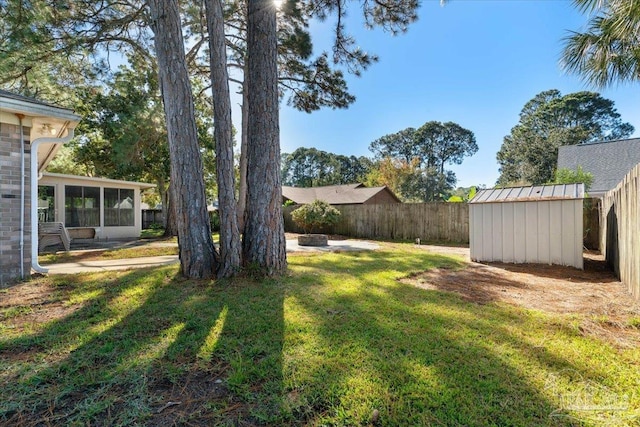 view of yard featuring a sunroom and a storage shed